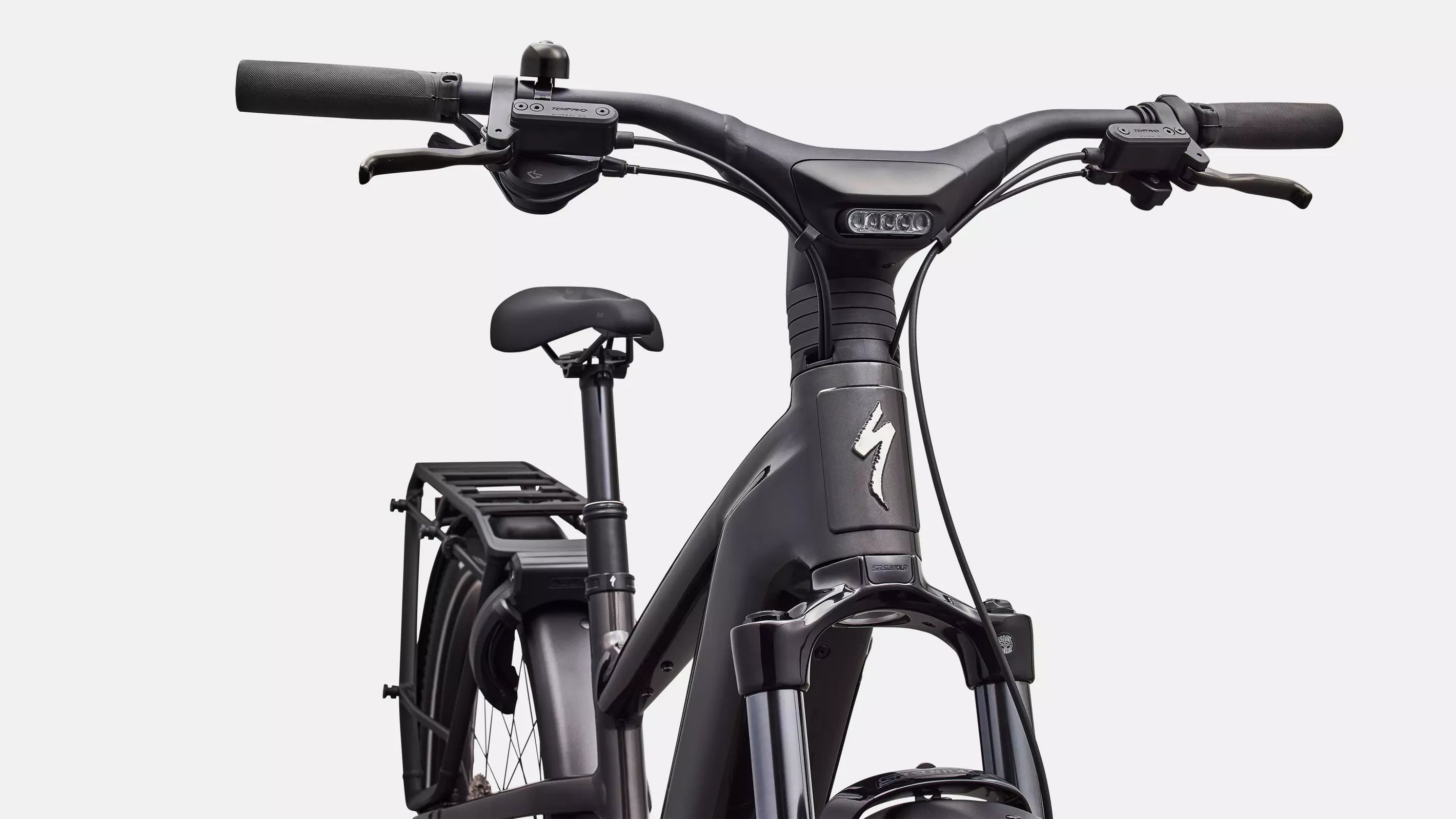 Close-up of a black bicycle with visible branding on a white background