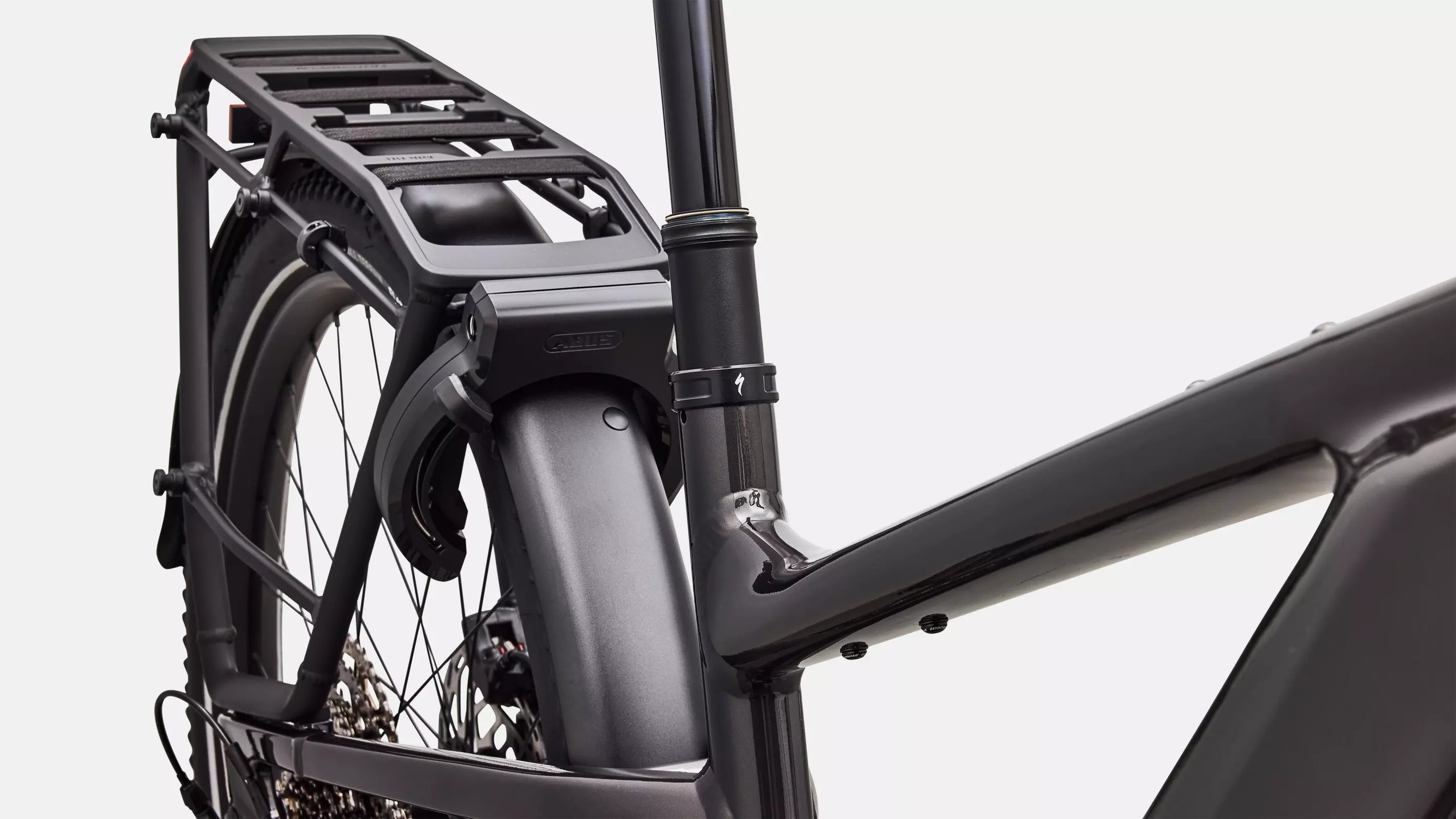 Close-up of a bicycle frame with a black rack on a white background